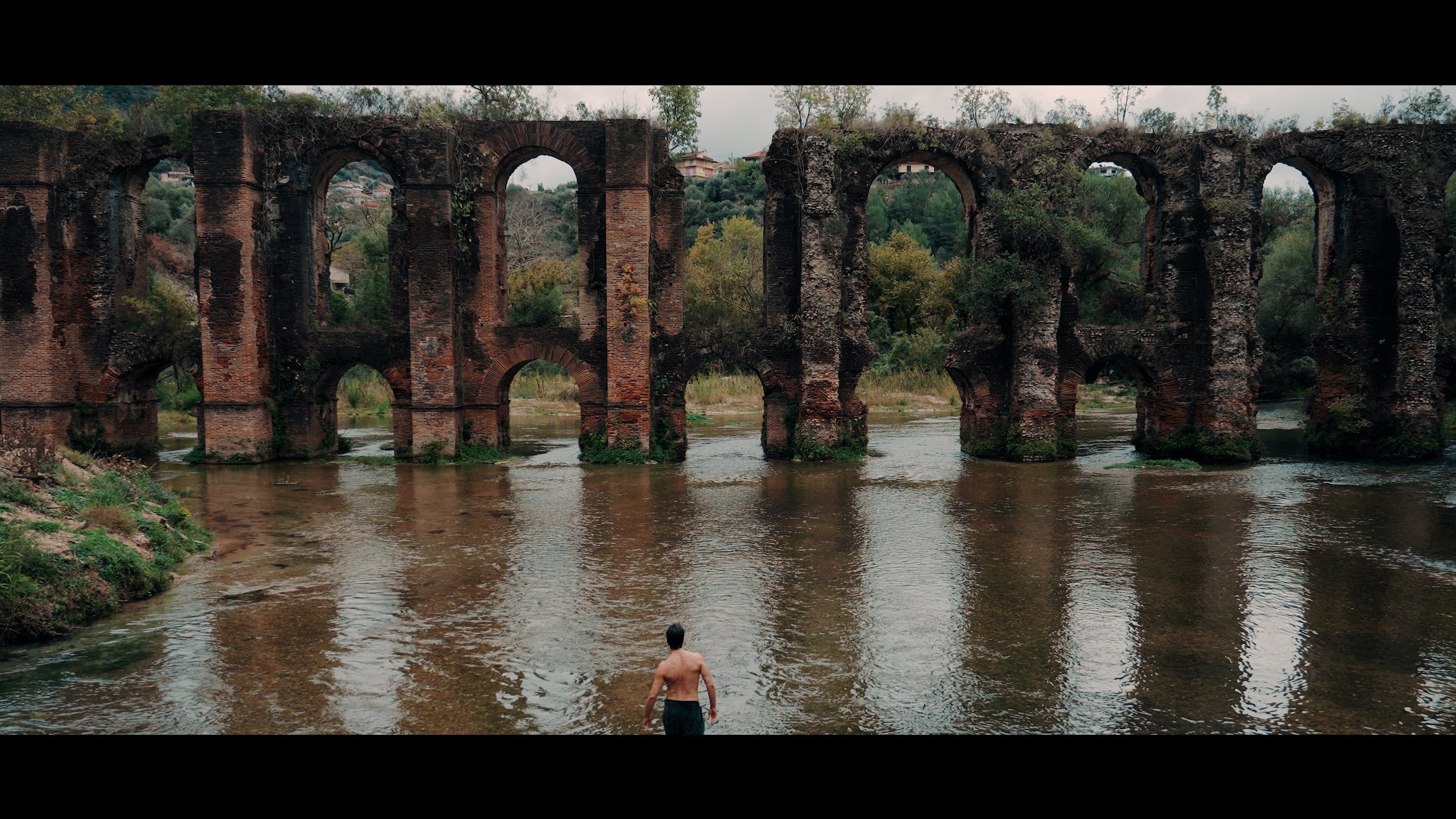 DANTE film still — the ancient bridge over water